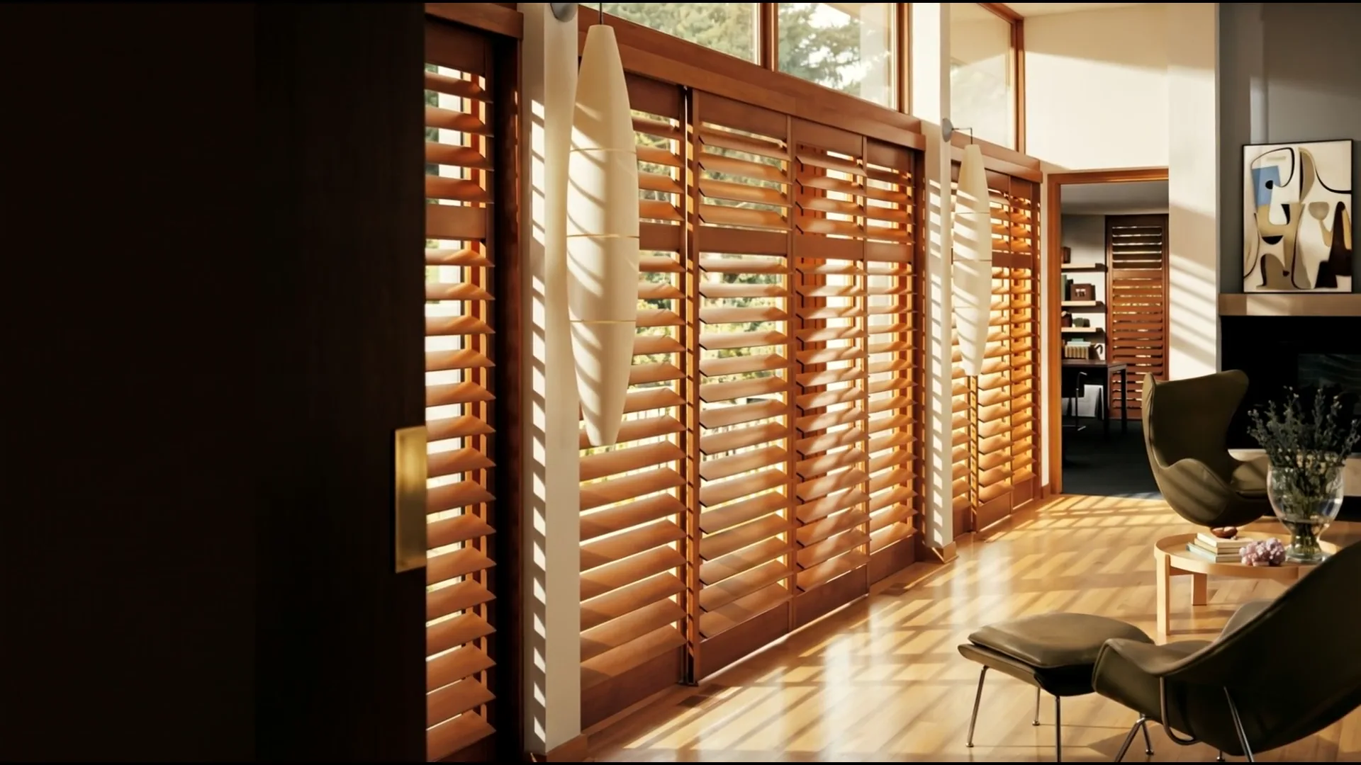 A premium New England living room dressed in Hunter Douglas Silhouette sheer shades, soft golden-hour light diffusing through the fabric.